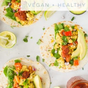 Whip together an easy and delicious tofu scramble for a savory vegan breakfast recipe! Pile with all the toppings like cilantro, avocado, and salsa for some loaded breakfast tacos! #vegan #vegetarian #glutenfree #tacos #healthy #cleaneating #veganbreakfast #tofuscramble | mindfulavocado