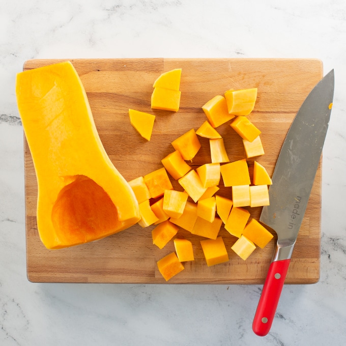butternut squash on cutting board with knife