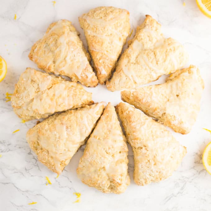 8 lemon scones in a circle on a marble background