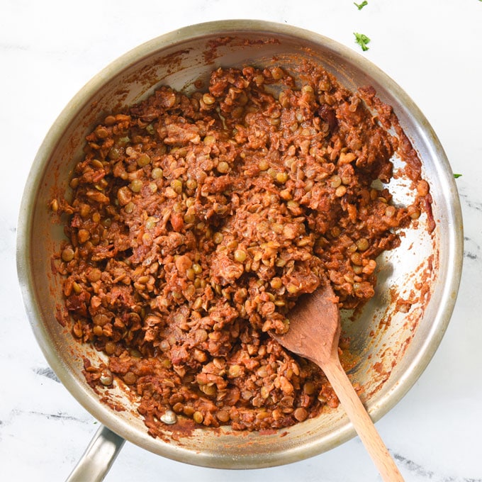 lentil walnut taco meat in pan with wooden spoon