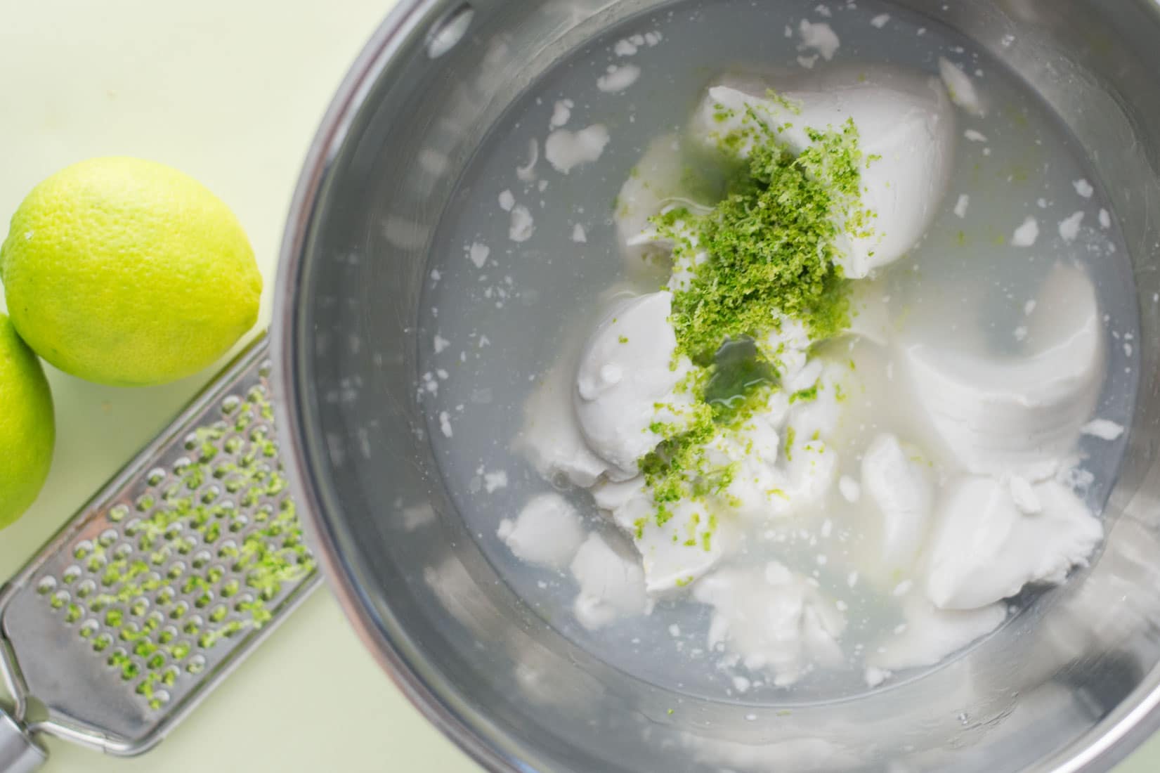 coconut milk and lime zest in stainless steel saucepan