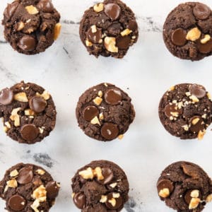 overhead shot of brownie bites topped with nuts and chocolate chips