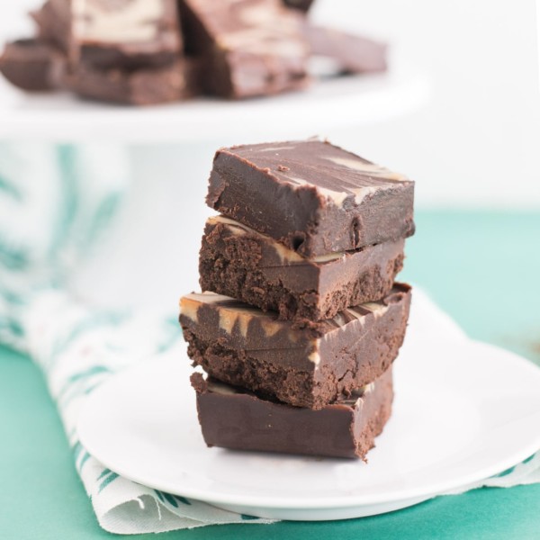 stack of vegan fudge on white plate on green background