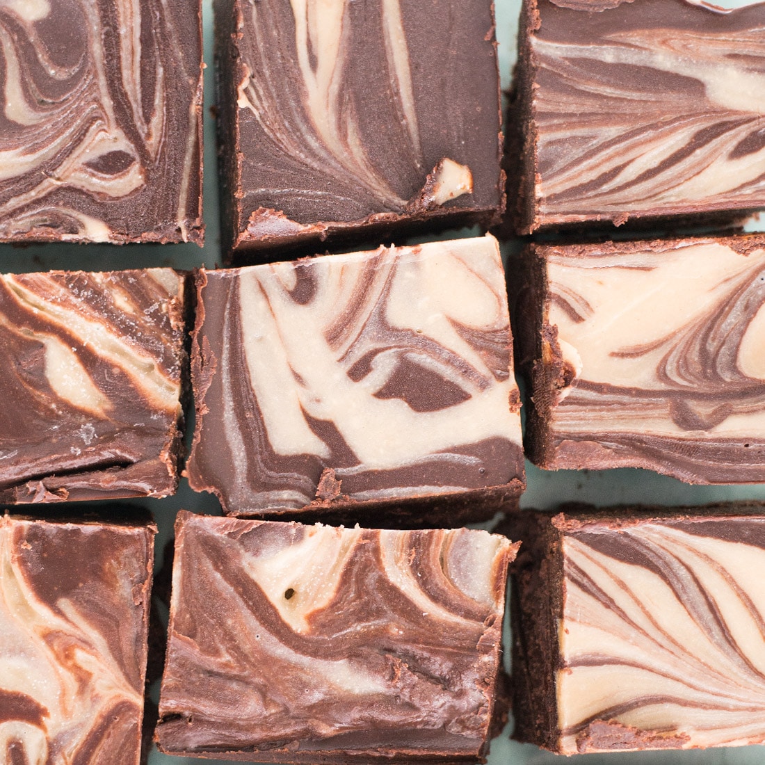 closeup shot of vegan fudge with tahini swirl. fudge is cut into squares