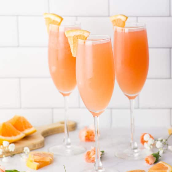 rose mimosa with grapefruit juice on marble counter with flowers