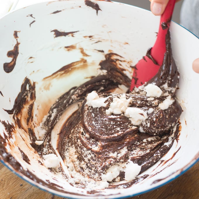 mixing egg whites and chocolate to make chocolate mousse in mixing bowl