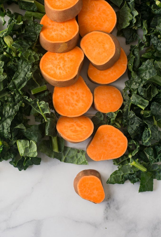 sweet potato and kale on marble background
