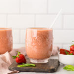 vegan strawberry basil kombucha smoothie in a glass on a white background