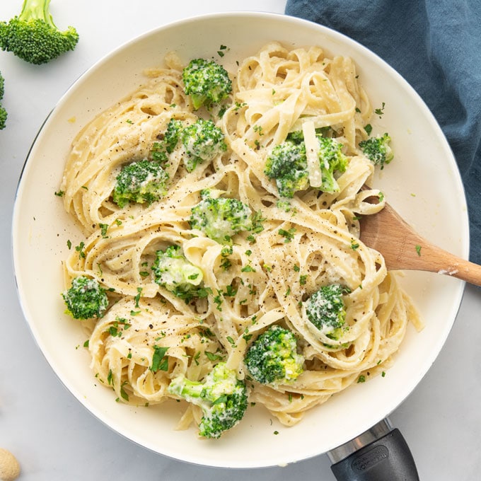 vegan fettuccine alfredo in pan with broccoli