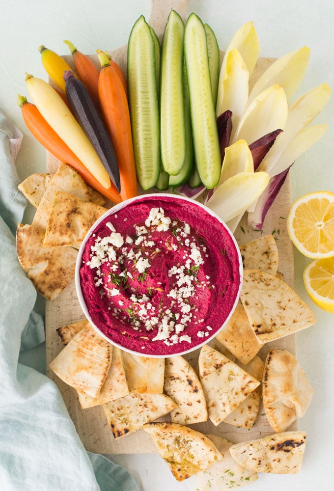 homemade beet hummus with dill, lemon, and feta. Paired with homemade pita chips, carrots, cucumbers, and endives