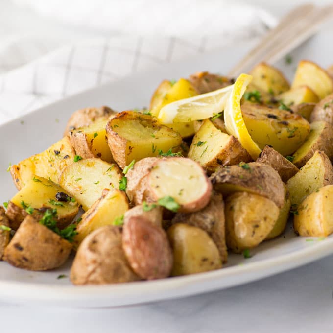 roasted red potatoes with lemon and dill on serving platter