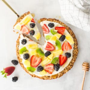 healthy fruit pizza with granola crust, greek yogurt, and fresh fruit