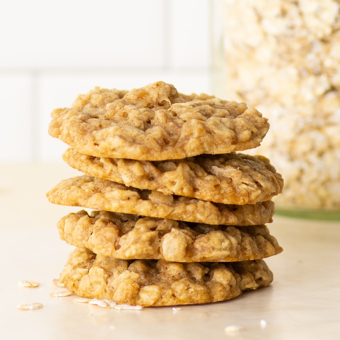 stack of vegan oatmeal cookies with oats in the background