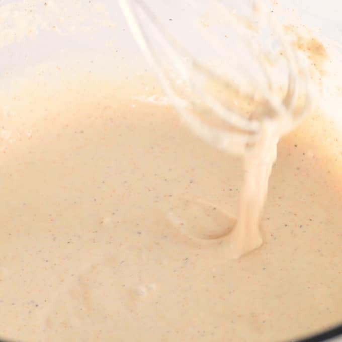 cauliflower bite batter in mixing bowl with whisk