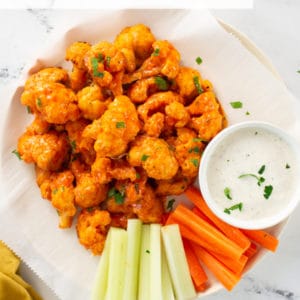 Vegan Buffalo Cauliflower wings are a healthy plant-based snack and so easy to make! With a gluten-free option, it's so easy to make an appetizer everyone can enjoy. #buffalocauliflowerwings #vegancauliflowerwings #cauliflowerbites #veganappetizer | Mindful Avocado