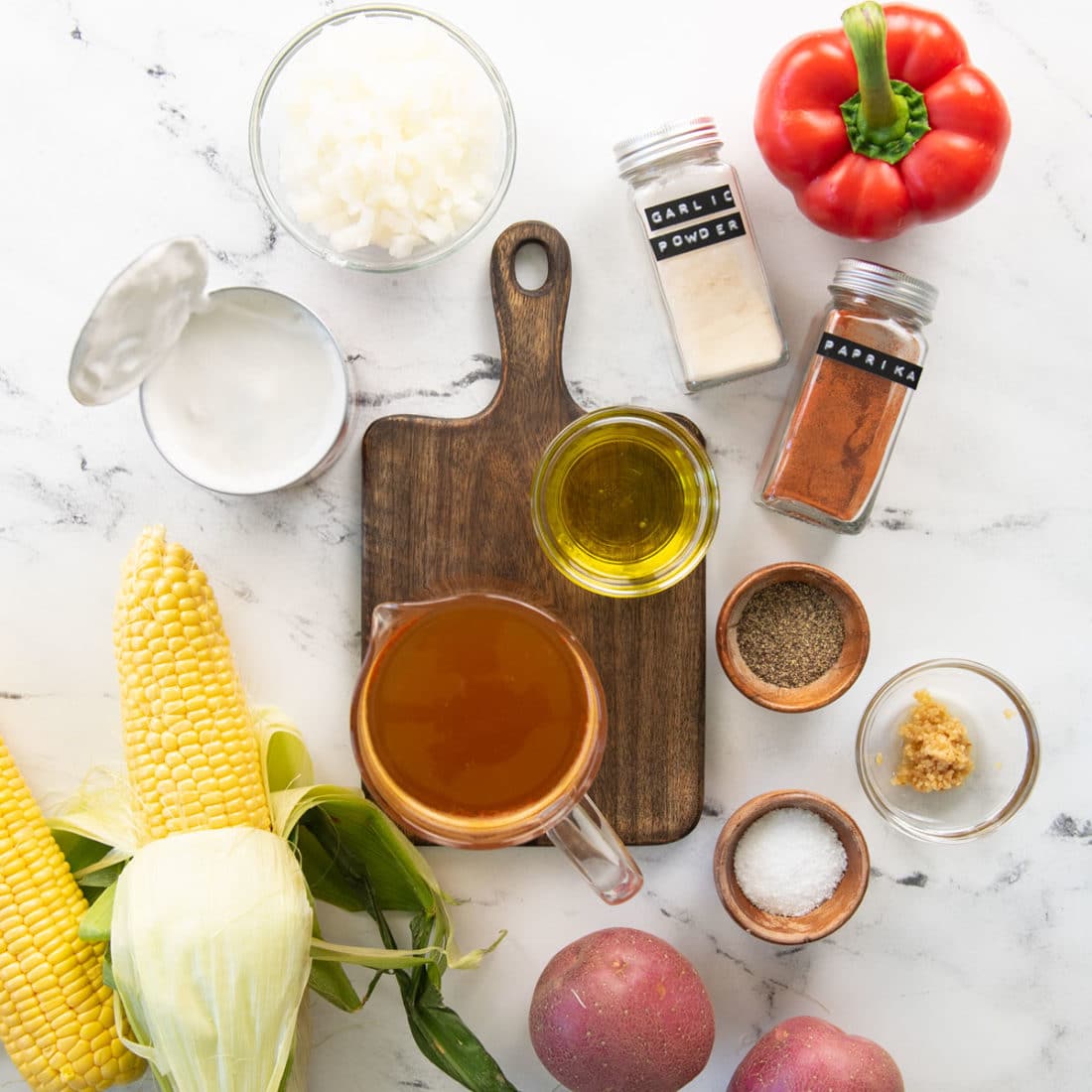 ingredients for vegan corn chowder on white background