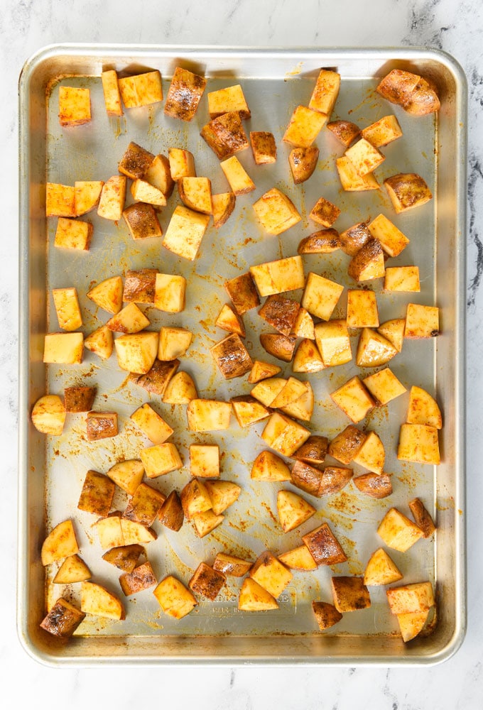 potatoes on a baking sheet before going in the oven