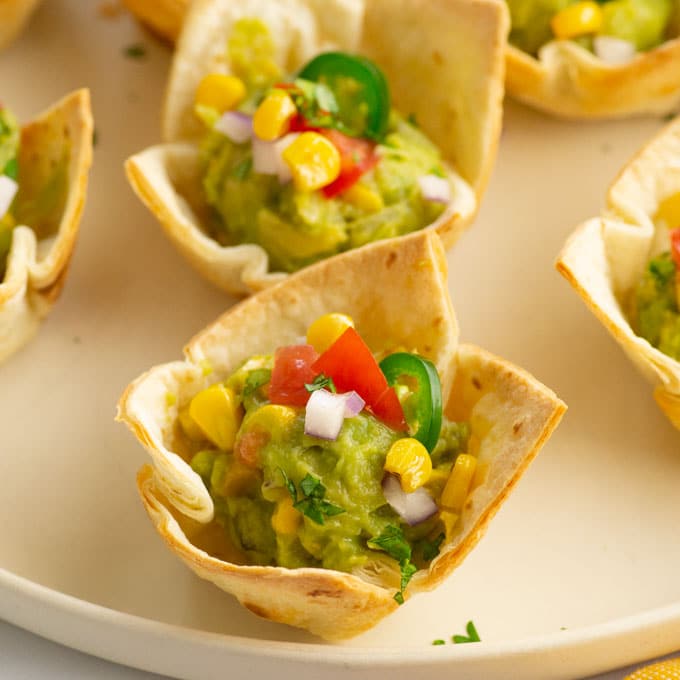 guacamole in a tortilla cup on a plate