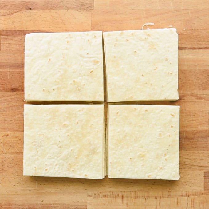 cut tortillas on cutting board