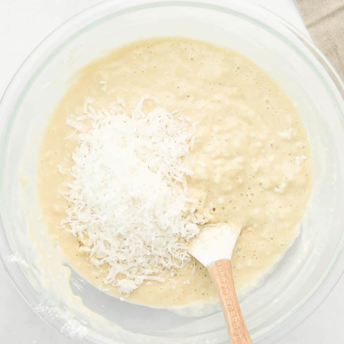 coconut in cake batter in mixing bowl
