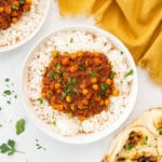 vegan chana masala in bowl with rice. served with naan