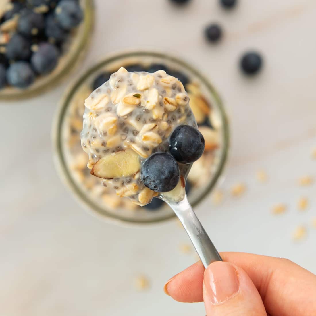 scoop of chia and oat pudding with blueberries and almonds