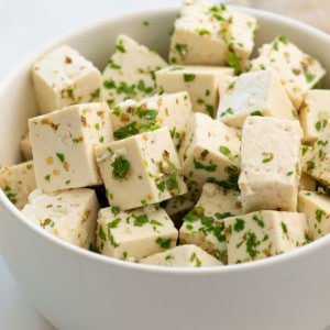 up close view of cubes of vegan feta cheese with seasonings
