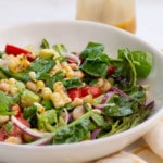 closeup of salad with grilled corn, tomatoes, beans, avocado, and red onion