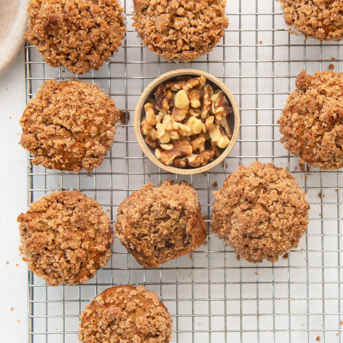 baked plant-based banana muffins with streusel topping cooling on a wire rack