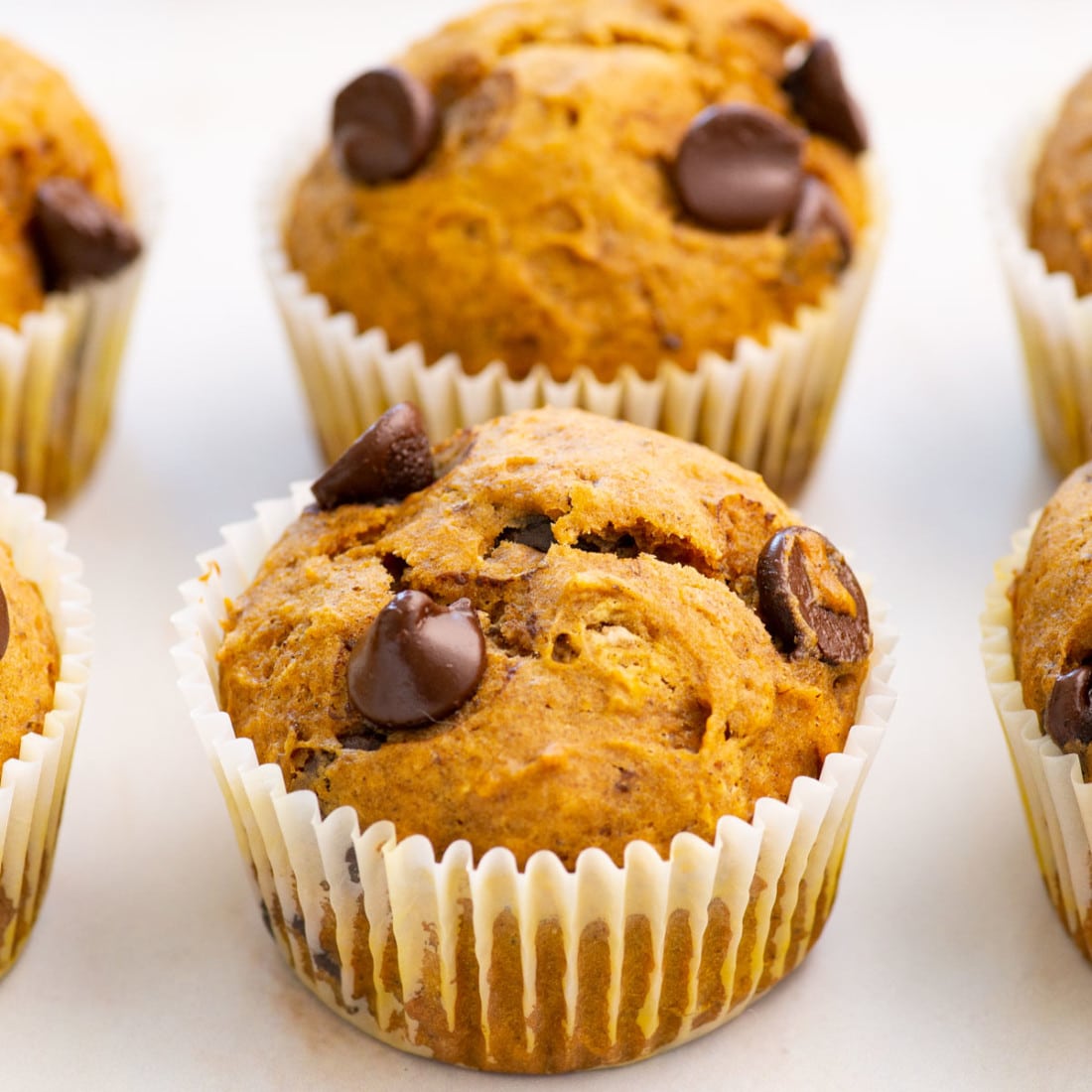 close up view of vegan pumpkin muffins with chocolate chips