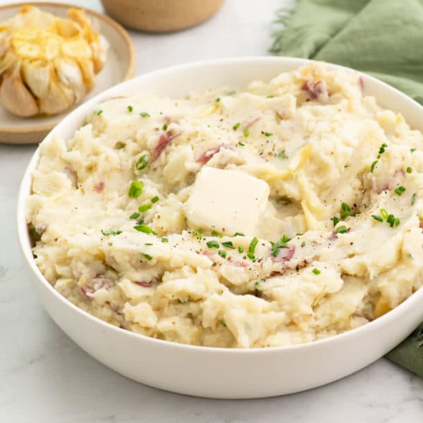 bowl of garlic mashed potatoes topped with chives